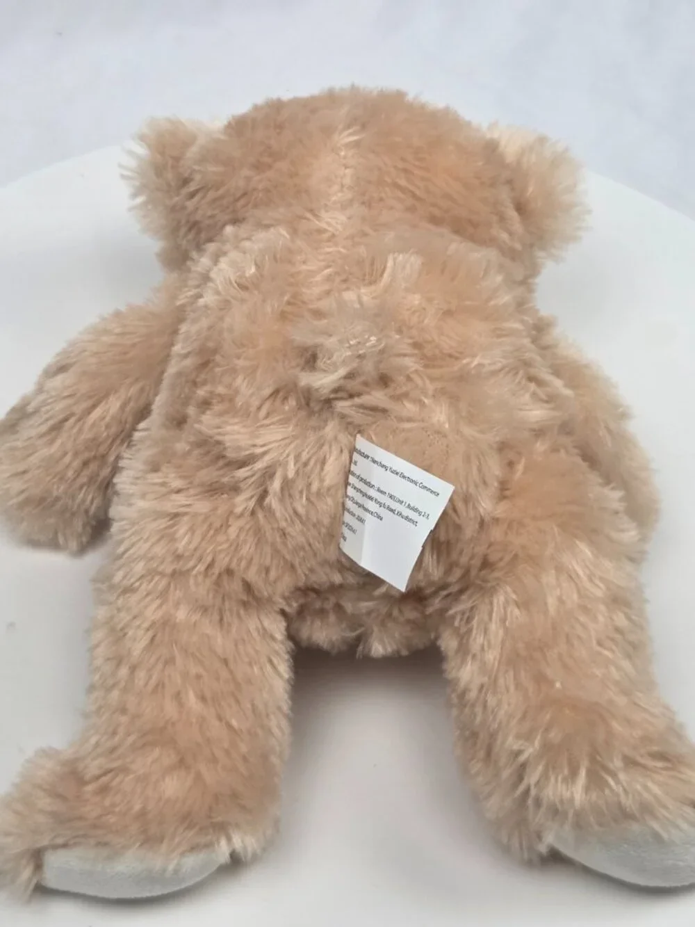 light brown plush teddy bear featuring a brown satin bow 9